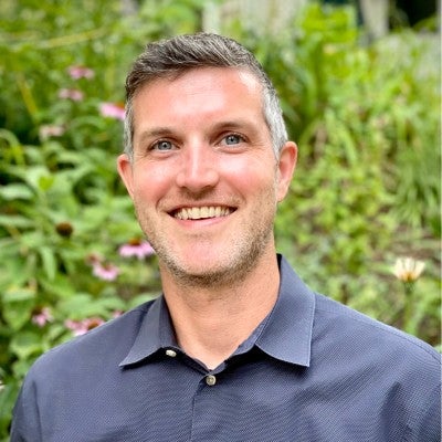 Headshot of Ian, smiling.