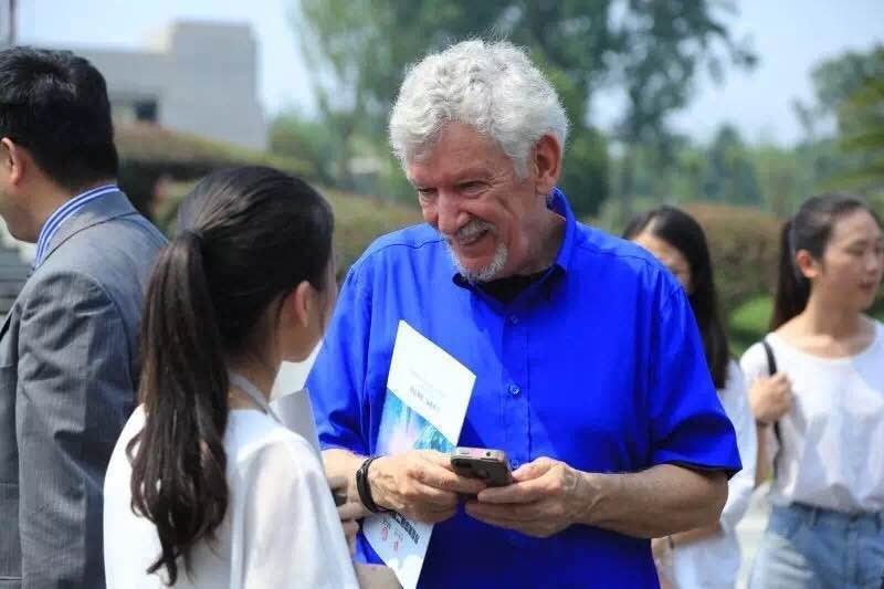 Photograph of Jackson pausing to speak with someone, smiling