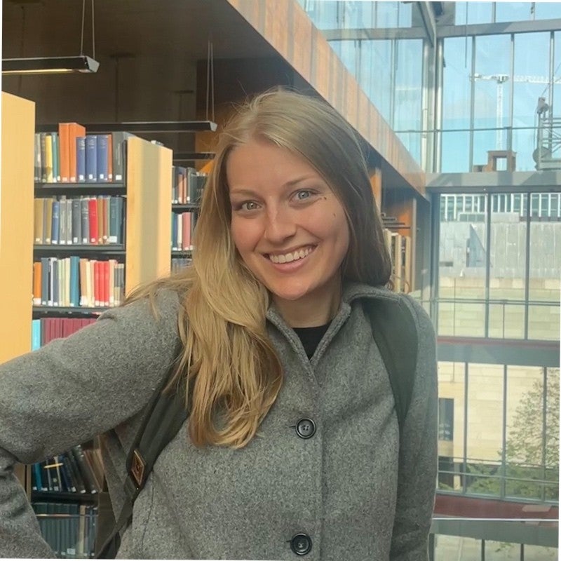 Portrait of Taylor smiling in a library