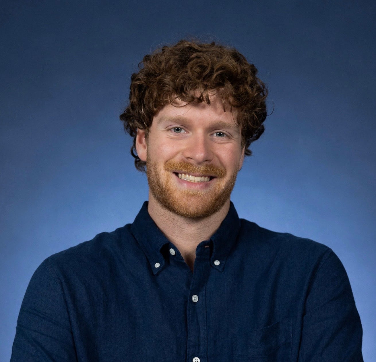 Portrait of Austin in a blue button-up shirt