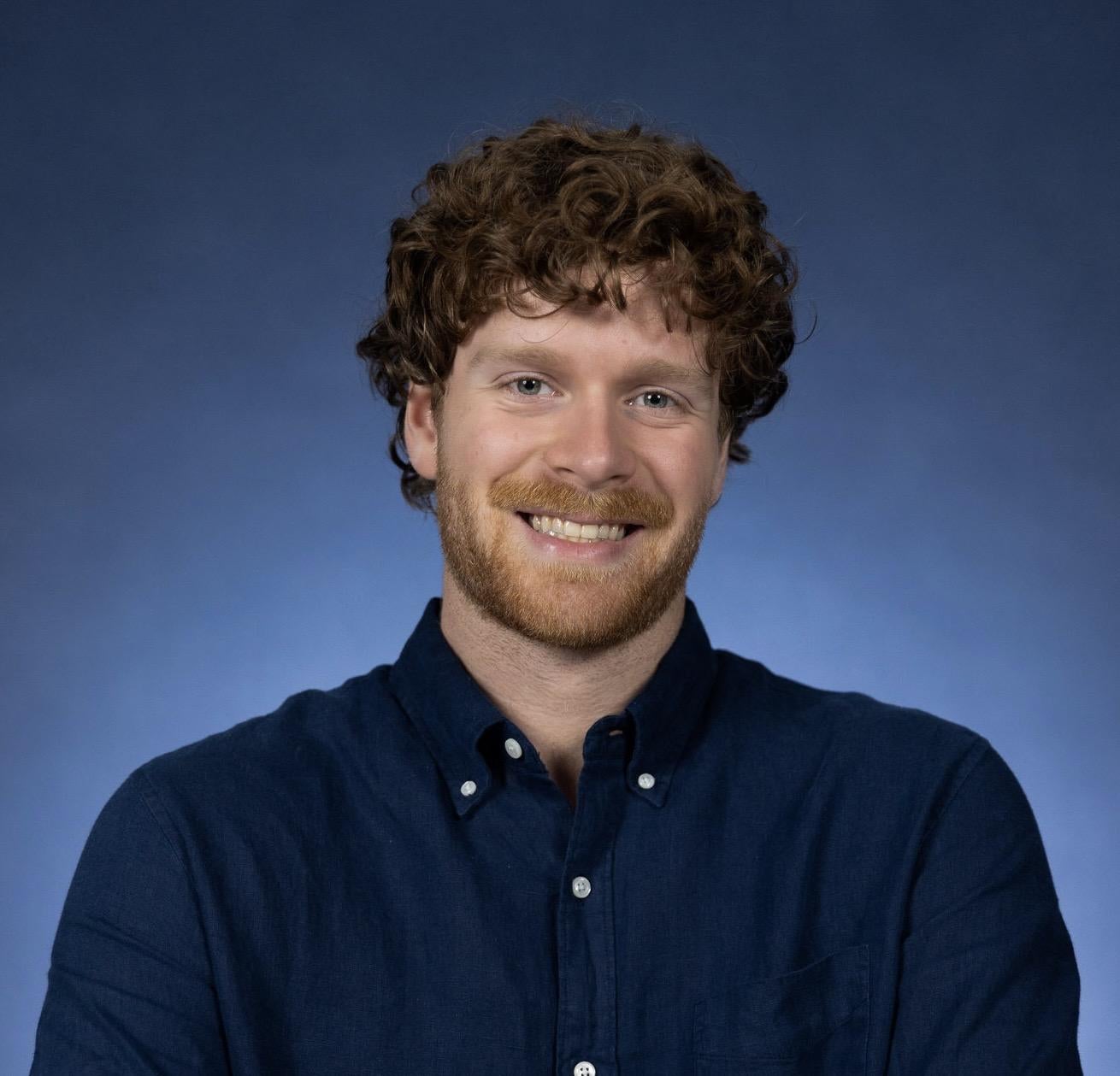 Portrait of Austin in a blue button-up shirt